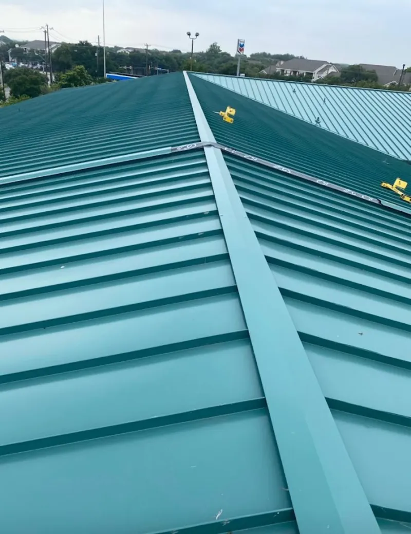 Green commercial metal roof ridge and valley for Metal Roof Repair in Bellefontaine Neighbors